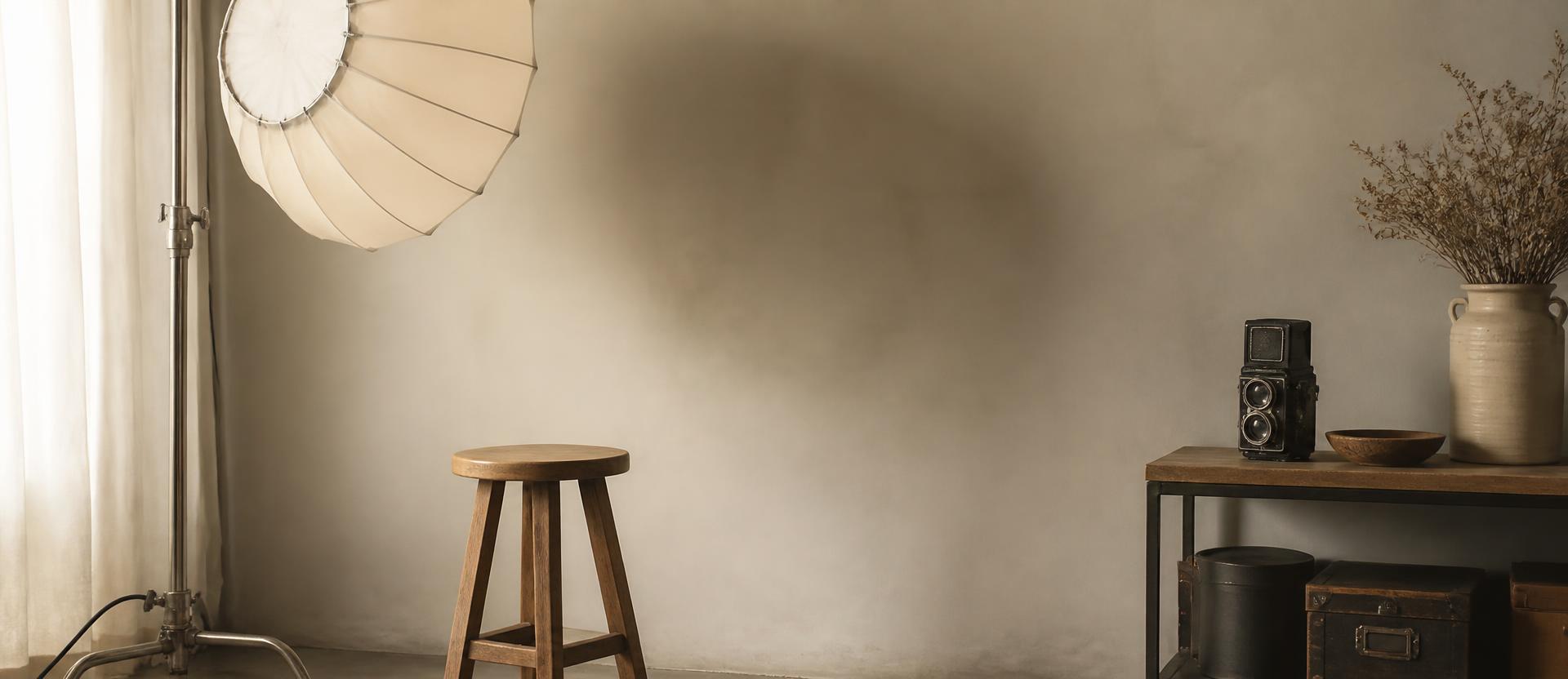 A quiet corner of the Dielsdorf studio with a wooden stool and diffused light